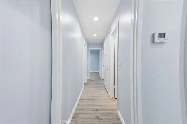 a view of a hallway with wooden floor