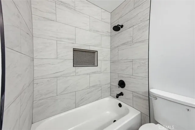 a bathroom with a bathtub and shower