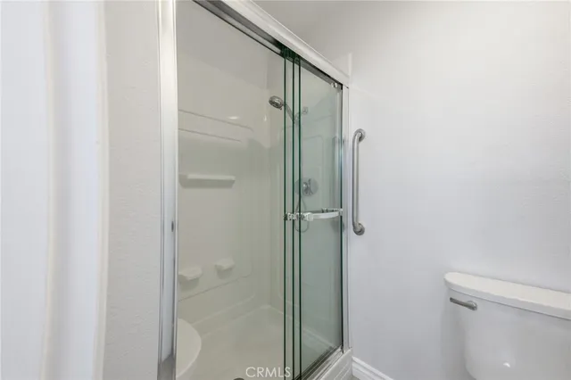 a bathroom with a shower and a toilet