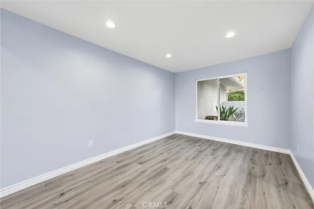 a view of room with window and wooden floor