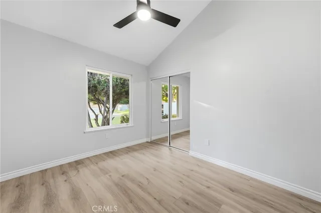 an empty room with windows and closet