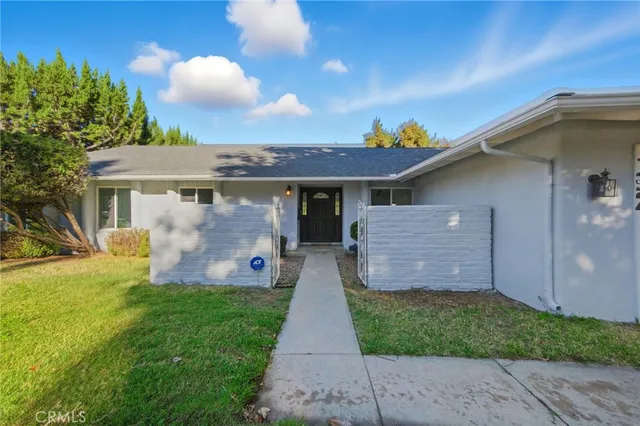 a front view of a house with a garden and yard