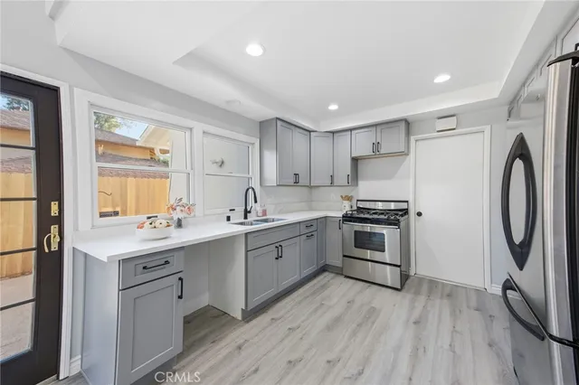 a kitchen with a sink cabinets and stainless steel appliances