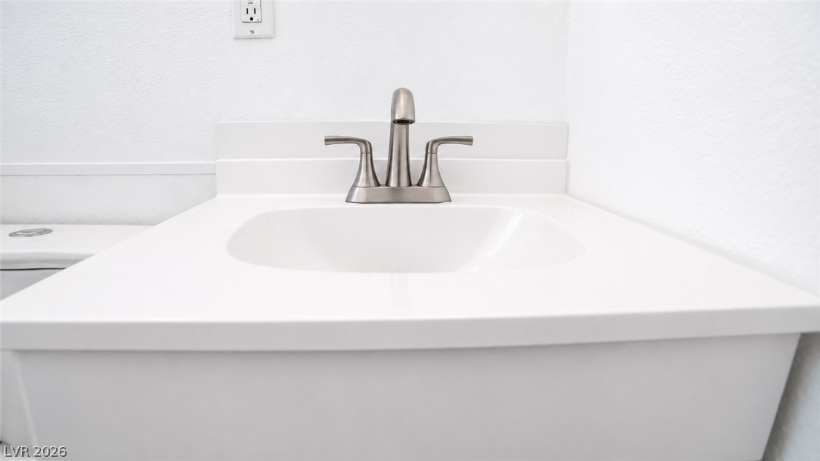 2870 South Sandhill Road Las Vegas, NV 89121 - Photo 48 of 64 A pristine white vanity with a brushed nickel faucet adds a touch of modern simplicity to the space.