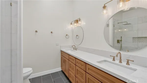 a bathroom with a shower a toilet and sink