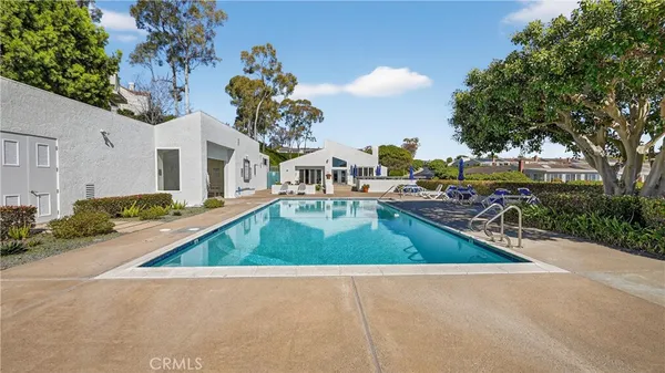 a living room with furniture a table and large windows