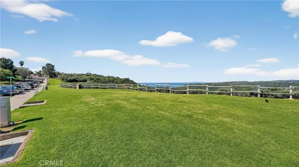 a view of a dry yard with wooden floor and a mountain