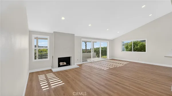 a view of kitchen with kitchen island wooden floor and window