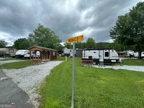 a view of a patio with table and chairs potted plants with wooden fence
