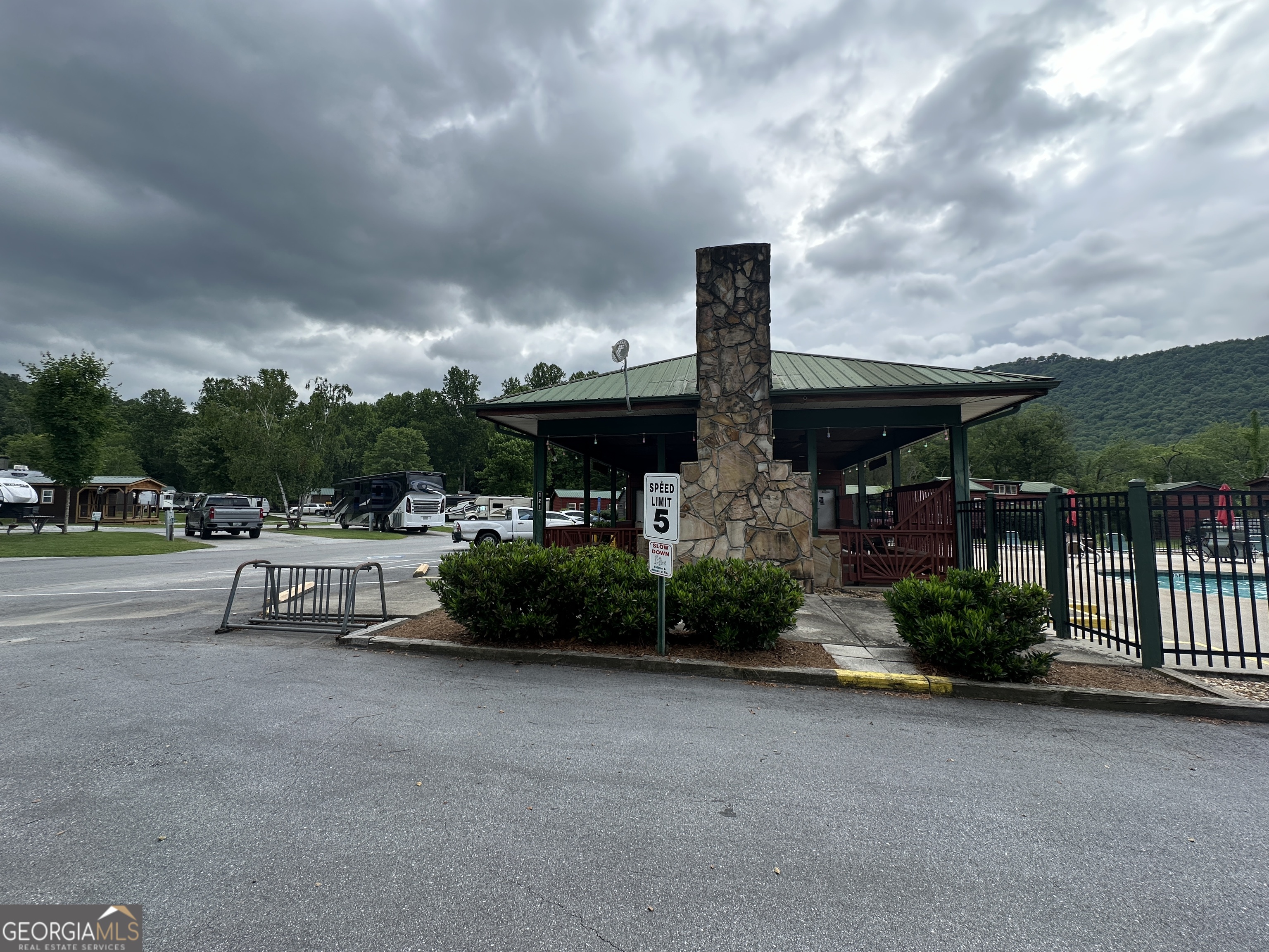 41 Monaco Lane Dillard, GA 30537 - Photo 12 of 16 a view of a patio with table and chairs potted plants with wooden fence