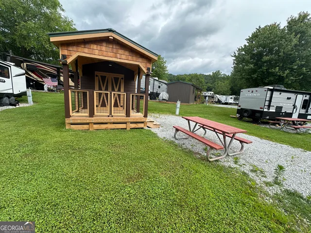 a view of a house with a yard and deck