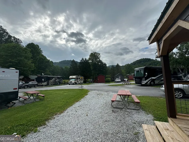 a view of a backyard with sitting area