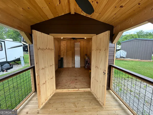 a view of a hallway with closet and wooden floor