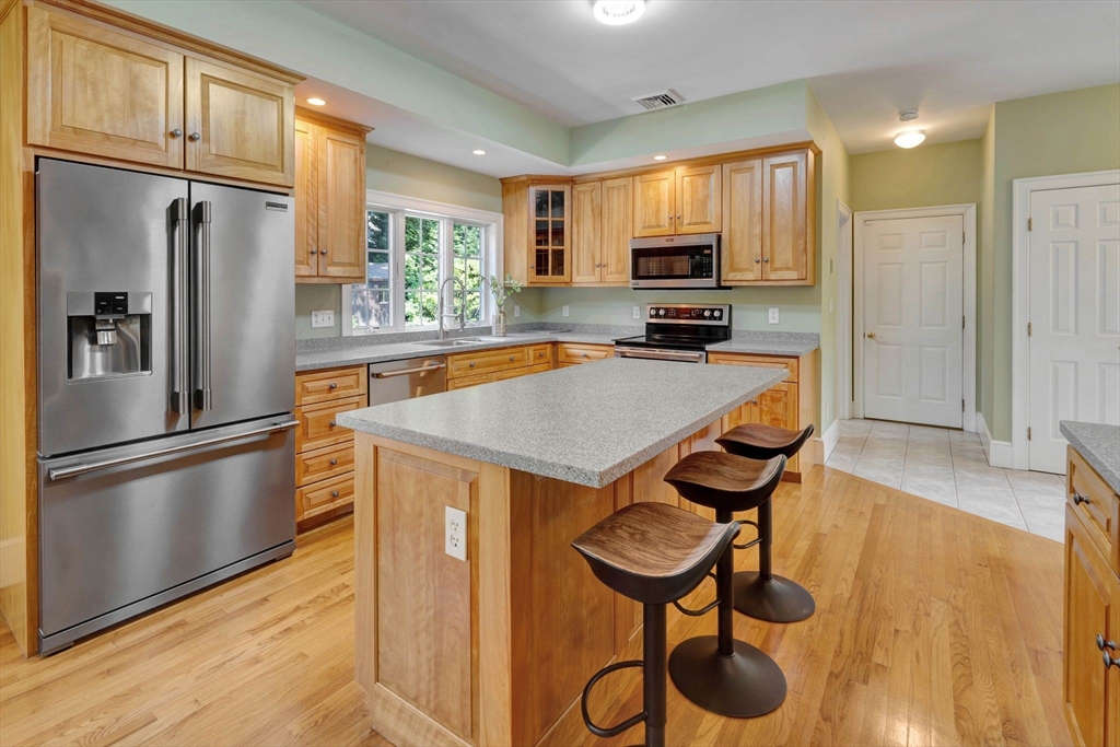 5 Chapel Hill Road Beverly, MA 01915 - Photo 17 of 41 a kitchen with stainless steel appliances a refrigerator stove microwave and cabinets