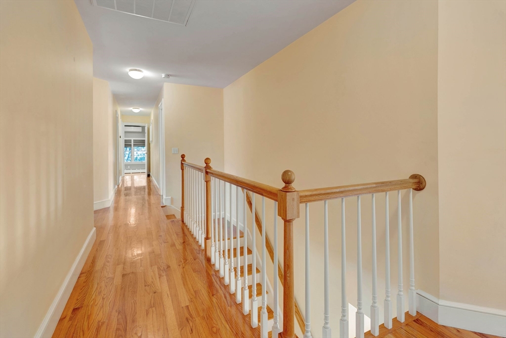 5 Chapel Hill Road Beverly, MA 01915 - Photo 29 of 41 a view of a hallway with wooden floor and staircase