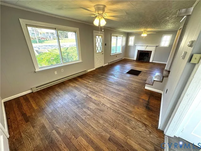 wooden floor in an empty room with a window
