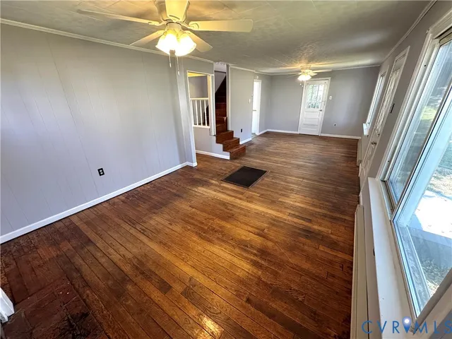 wooden floor in an empty room with a window