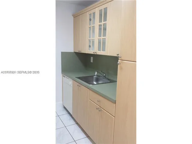 a kitchen with cabinets and sink