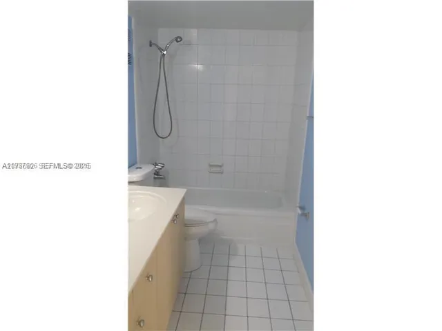 a en suite bathroom with a shower a mirror and a shower