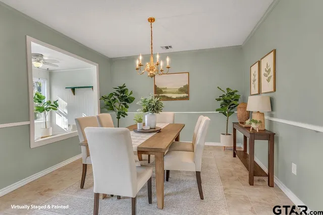 a view of a dining room with furniture and chandelier