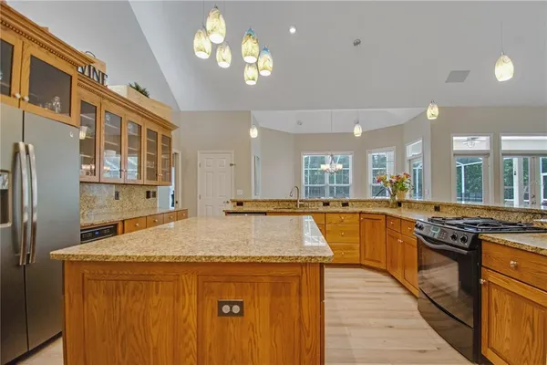 a kitchen with stainless steel appliances granite countertop a stove and a refrigerator