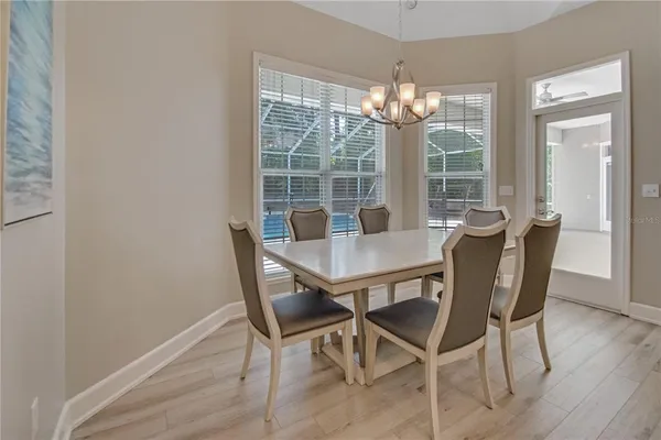 a view of a dining room with furniture wooden floor and chandelier