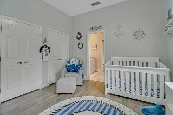 a bedroom with furniture and wooden floor