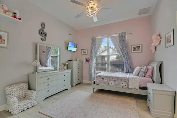 a bedroom with a bed and a chandelier