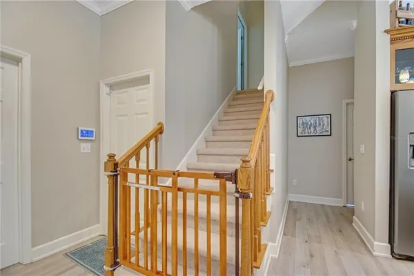 a view of entryway with wooden floor and stairs