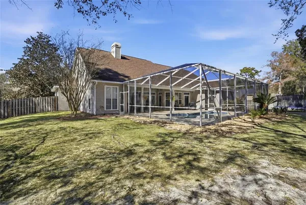 a view of a yard with wooden fence