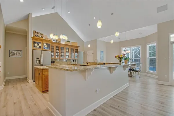 a kitchen with stainless steel appliances granite countertop a lot of counter space and wooden floors