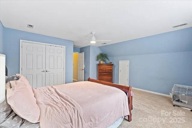 a bedroom with a bed a table and chair