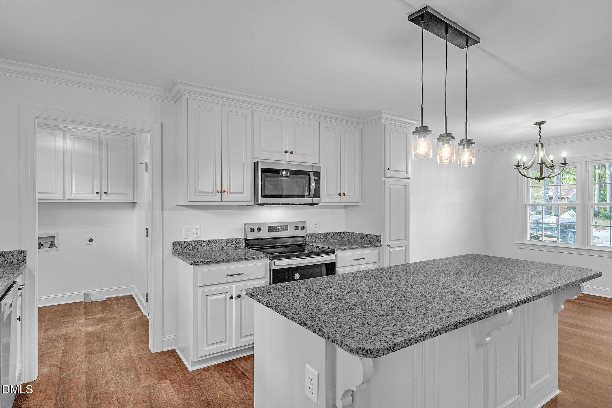 1219 Queen Anne Road Northwest Wilson, NC 27896 - Photo 9 of 26 a kitchen with granite countertop a sink a counter space appliances and cabinets