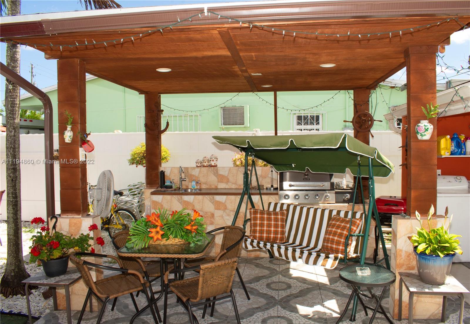 398 East 56th Street Hialeah, FL 33013 - Photo 11 of 30 a view of an outdoor dining space with a table and chairs