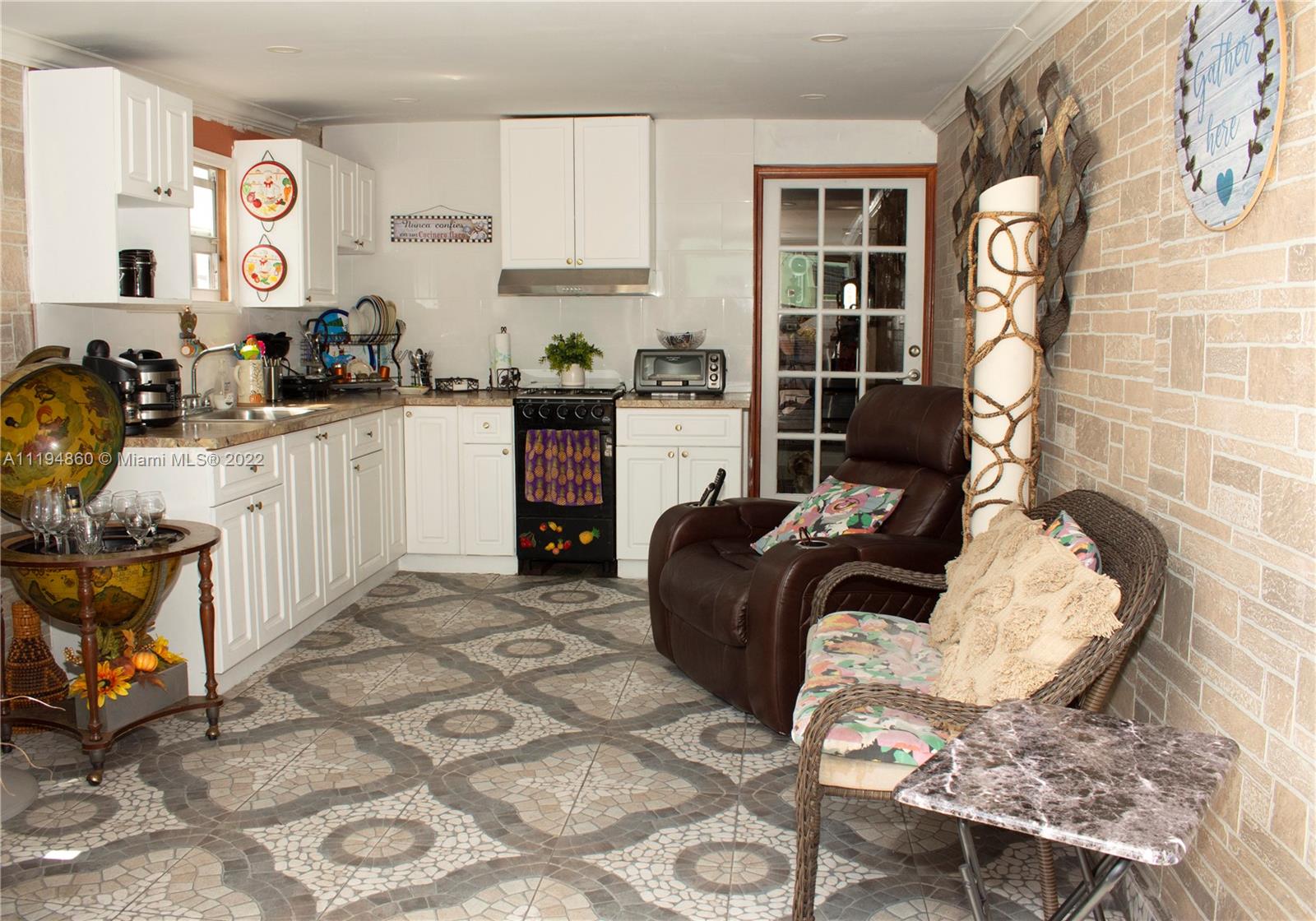 398 East 56th Street Hialeah, FL 33013 - Photo 13 of 30 a living room with furniture a rug and white walls