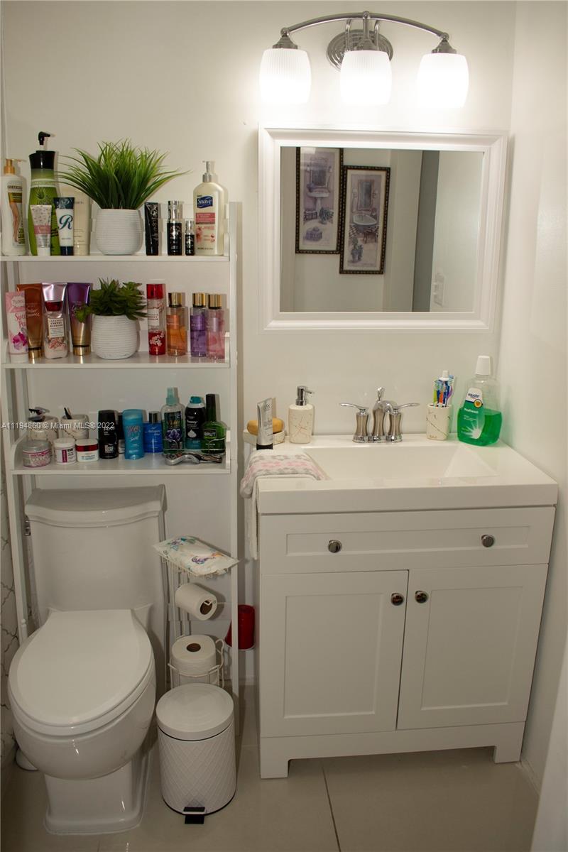 398 East 56th Street Hialeah, FL 33013 - Photo 18 of 30 a bathroom with a sink toilet and vanity
