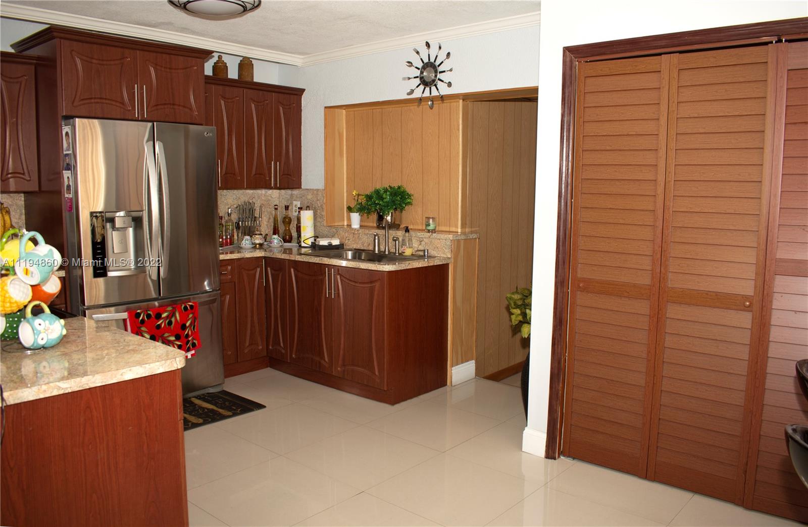398 East 56th Street Hialeah, FL 33013 - Photo 22 of 30 a kitchen with stainless steel appliances a refrigerator and a stove