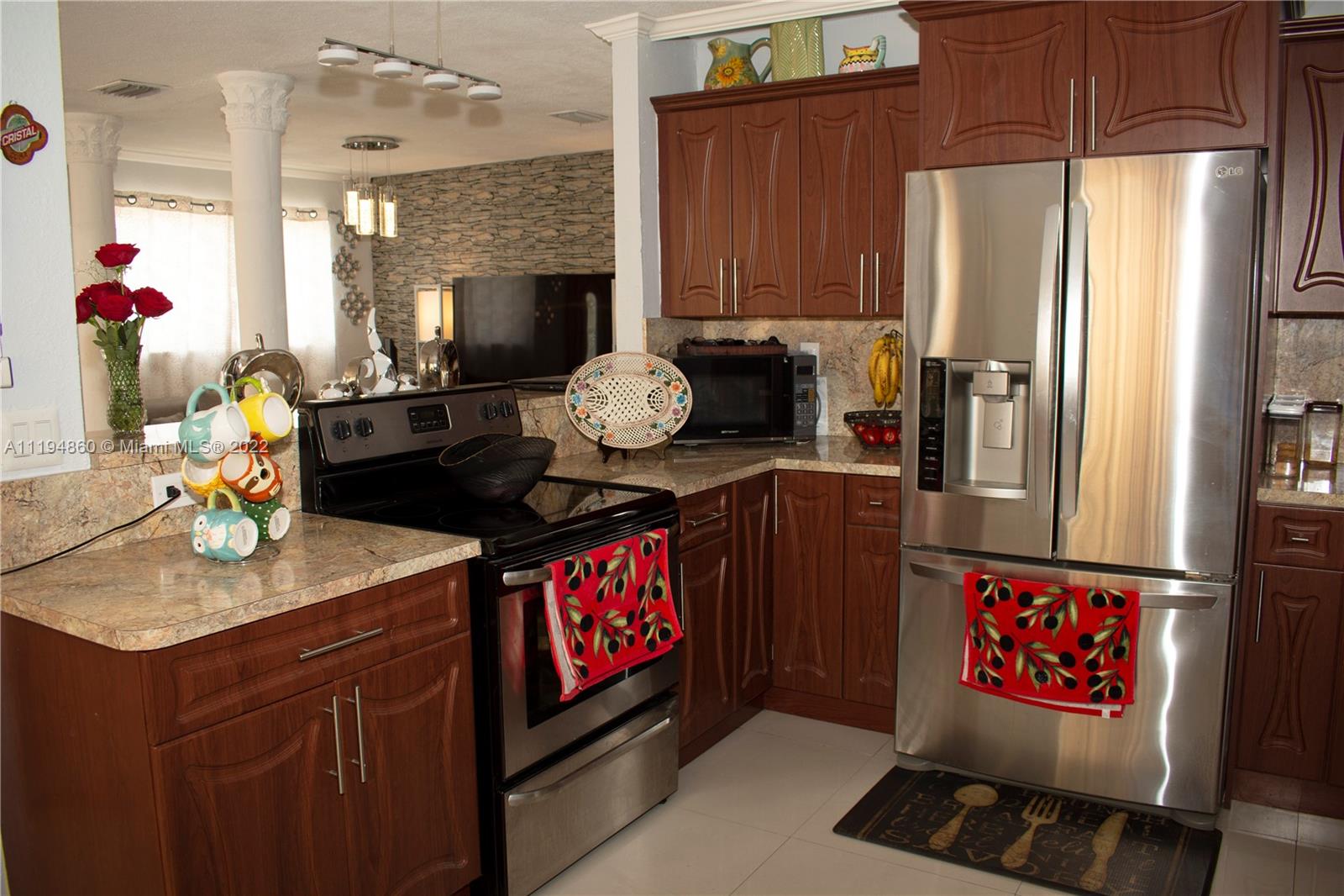 398 East 56th Street Hialeah, FL 33013 - Photo 23 of 30 a kitchen with stainless steel appliances granite countertop a refrigerator a stove and a sink