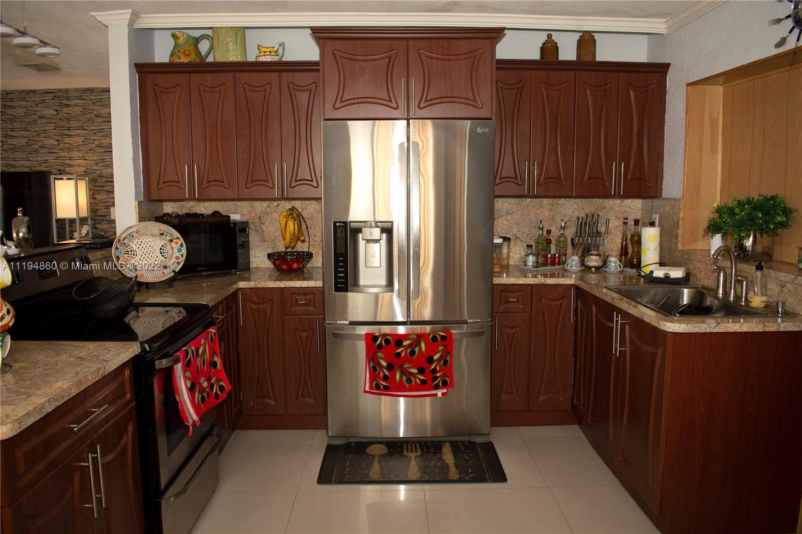 398 East 56th Street Hialeah, FL 33013 - Photo 24 of 30 a kitchen with stainless steel appliances granite countertop a stove a refrigerator and a cabinets