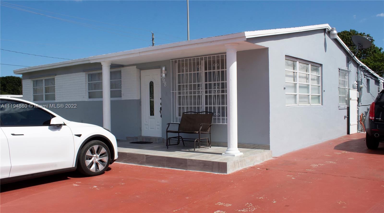 398 East 56th Street Hialeah, FL 33013 - Photo 3 of 30 a car parked in front of a house