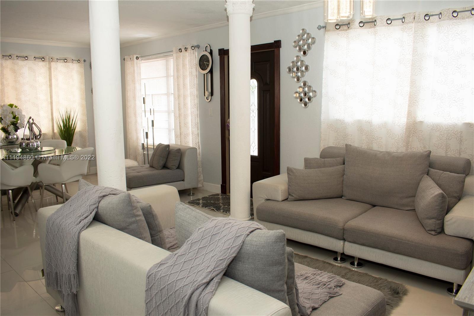 398 East 56th Street Hialeah, FL 33013 - Photo 4 of 30 a living room with furniture and a large window