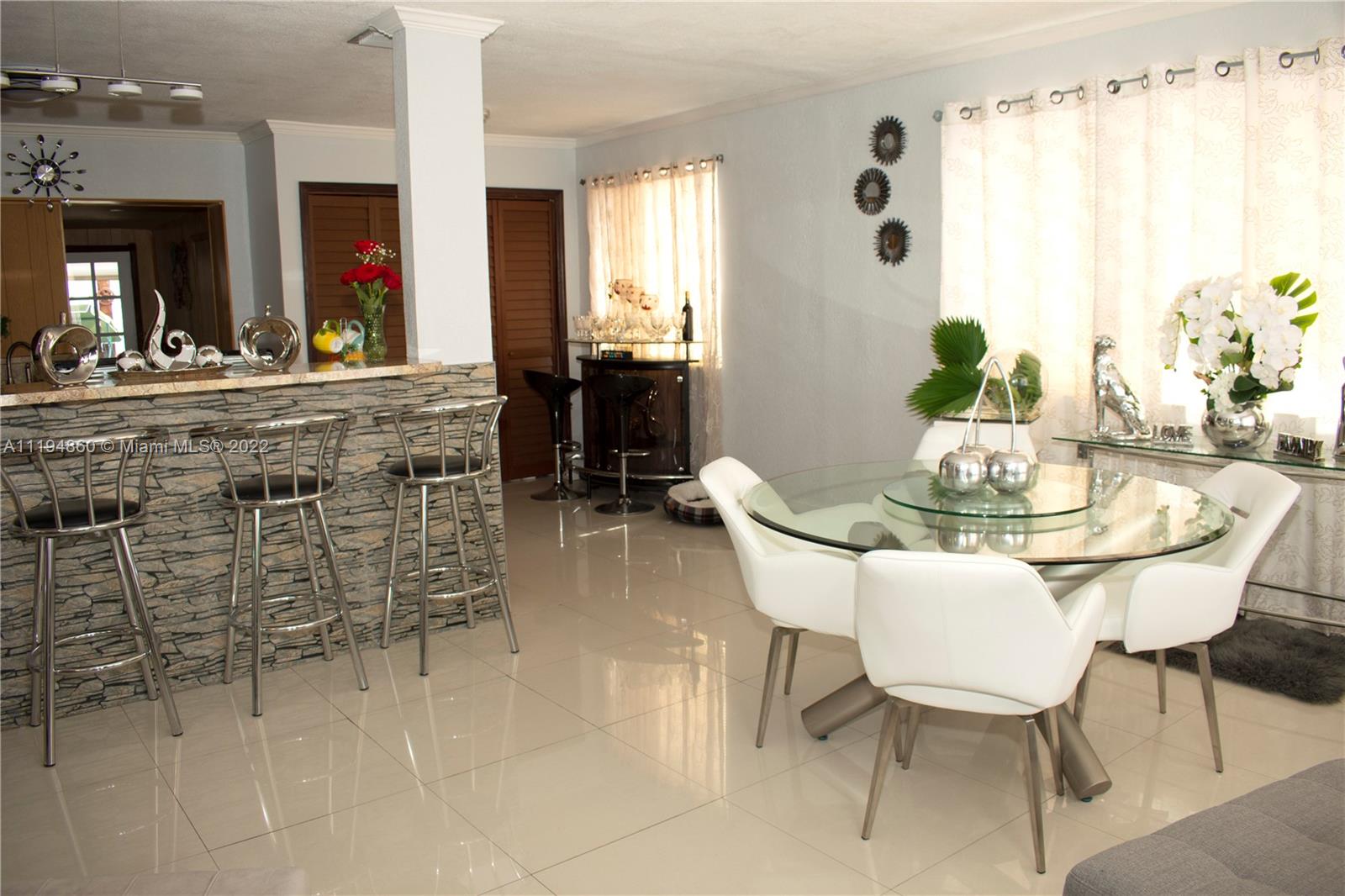 398 East 56th Street Hialeah, FL 33013 - Photo 6 of 30 a view of a dining room with furniture and a chandelier