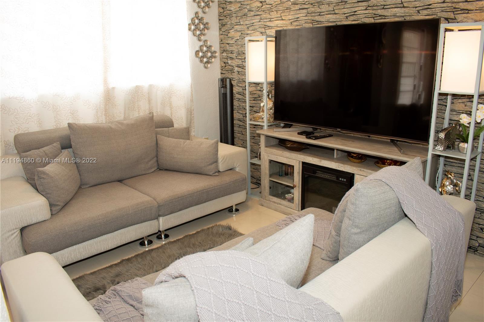 398 East 56th Street Hialeah, FL 33013 - Photo 7 of 30 a living room with furniture and a flat screen tv