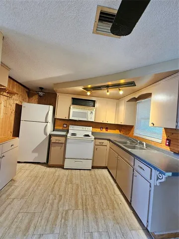 a kitchen with wooden floors and a sink