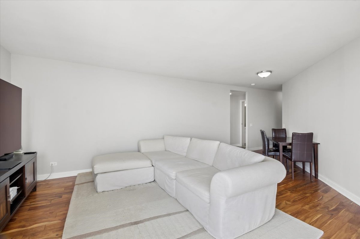 5320 North Sheridan Road, Unit 2403 Chicago, IL 60640 - Photo 6 of 18 a living room with furniture and a flat screen tv