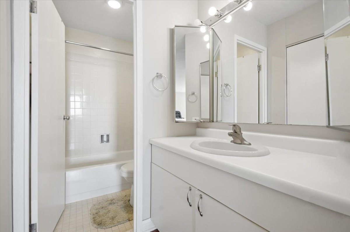 5320 North Sheridan Road, Unit 2403 Chicago, IL 60640 - Photo 9 of 18 a bathroom with a sink and a mirror