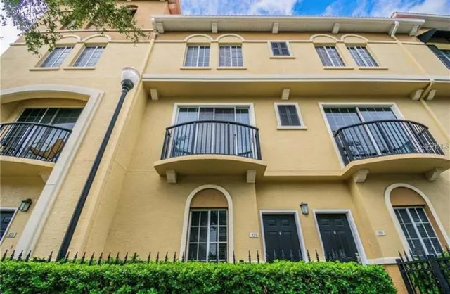 a front view of a house with many windows