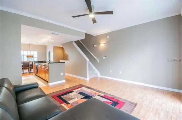 a living room with furniture and kitchen view