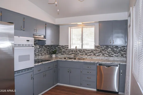 a kitchen with cabinets appliances and a counter space