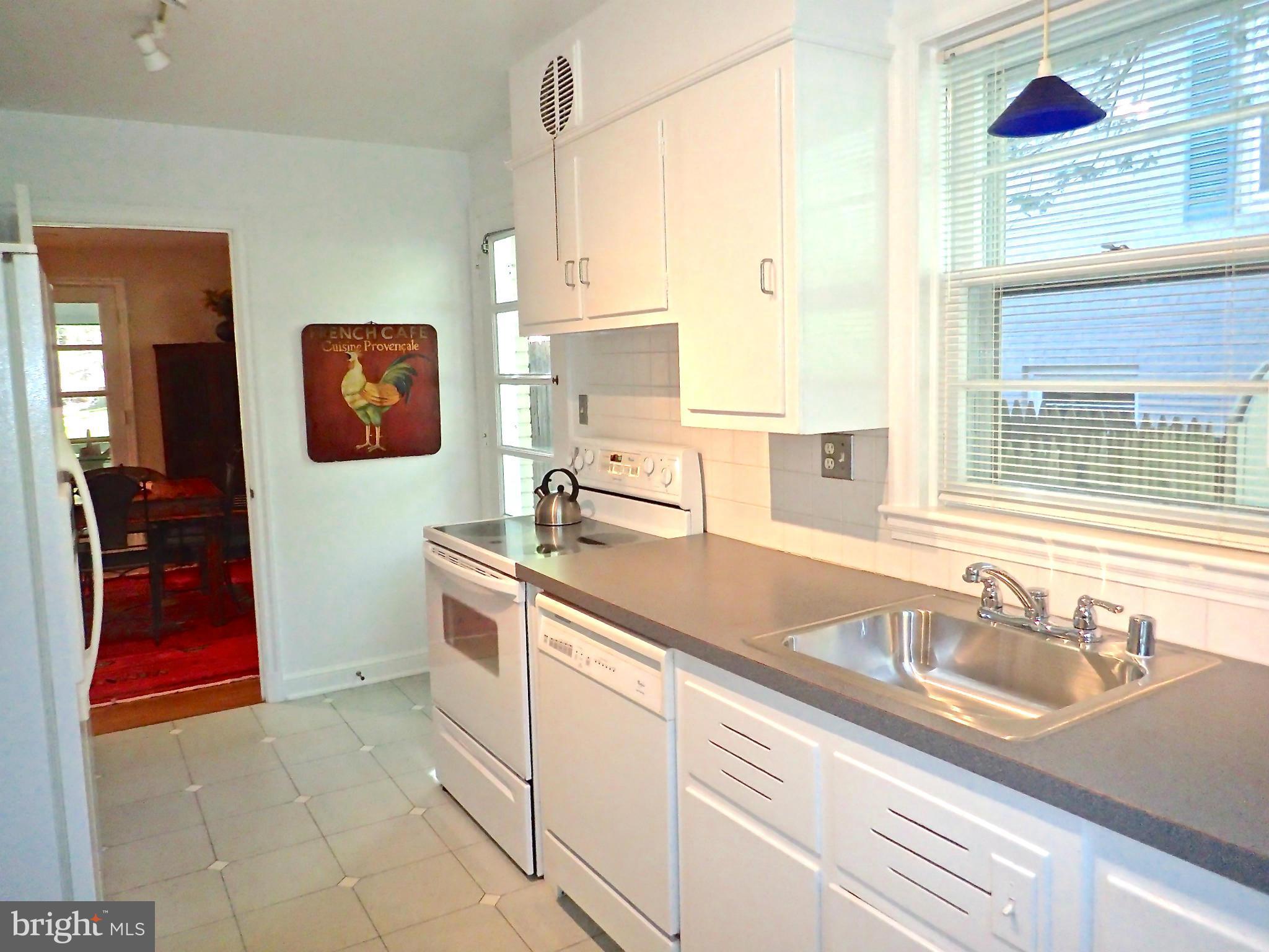 5123 Linnean Avenue Northwest Washington, DC 20008 - Photo 9 of 29 Sunny white kitchen w exit to side yard